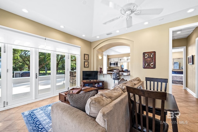 tiled living room with ceiling fan