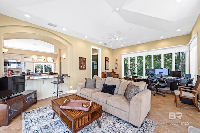 living room featuring plenty of natural light and ceiling fan