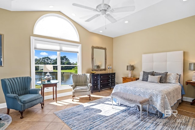 bedroom with ceiling fan, light tile patterned floors, vaulted ceiling, and multiple windows