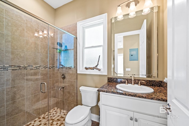 bathroom with vanity, toilet, and walk in shower