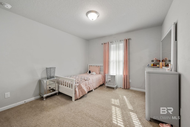 carpeted bedroom featuring a textured ceiling