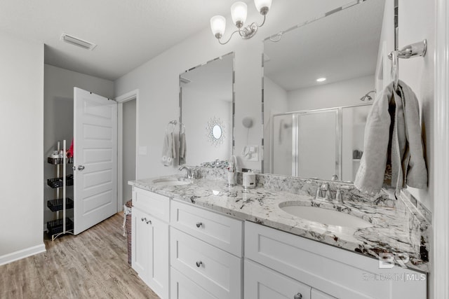 bathroom with vanity, hardwood / wood-style floors, and an enclosed shower