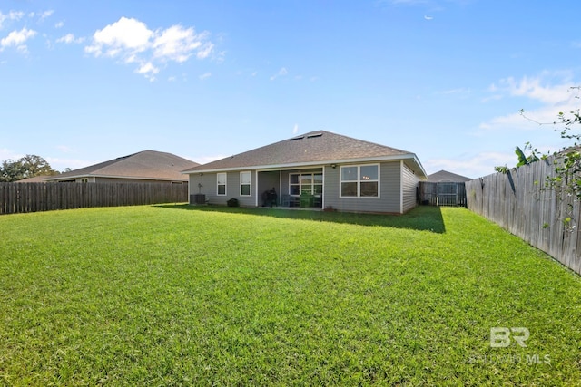 rear view of property with a yard