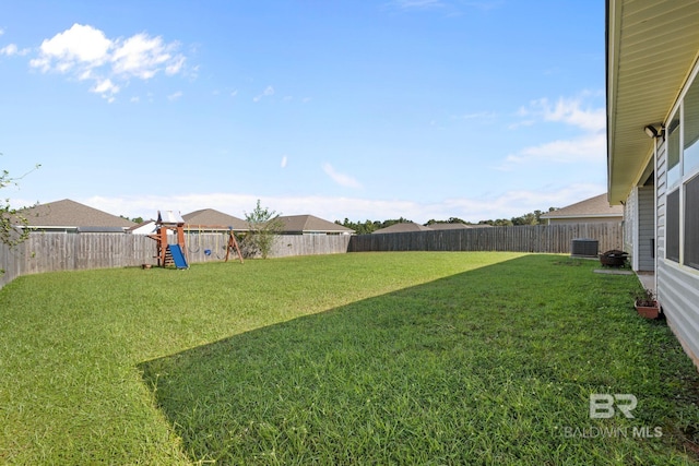 view of yard with cooling unit and a playground