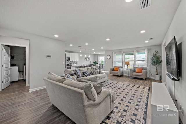 living room featuring a textured ceiling and dark hardwood / wood-style floors