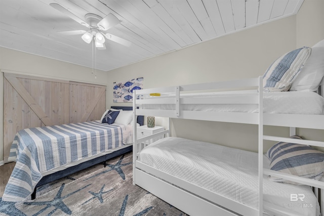 bedroom featuring hardwood / wood-style floors, ceiling fan, and wooden ceiling