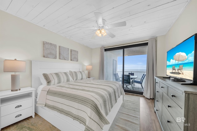 bedroom with access to exterior, floor to ceiling windows, wood ceiling, ceiling fan, and light hardwood / wood-style flooring