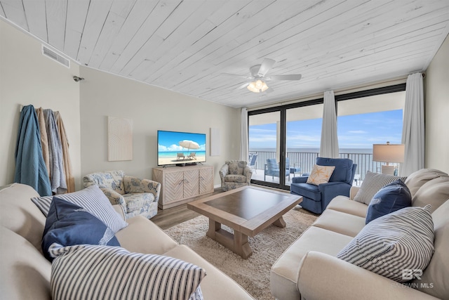 living room with light hardwood / wood-style floors, ceiling fan, wood ceiling, and a wall of windows