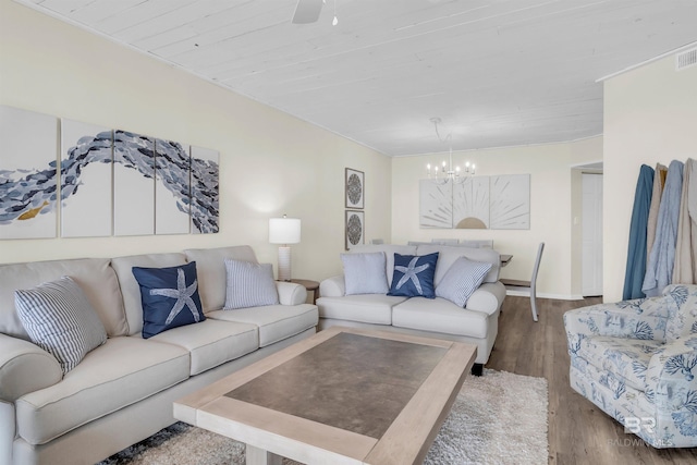 living room with hardwood / wood-style flooring, a notable chandelier, and wooden ceiling