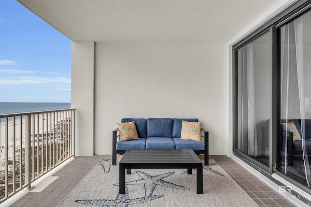 balcony featuring a water view and a beach view