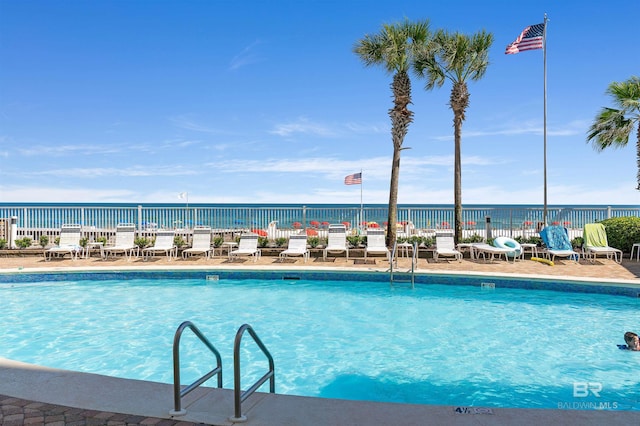 view of pool with a water view