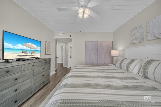 bedroom featuring hardwood / wood-style floors, ceiling fan, and wooden ceiling