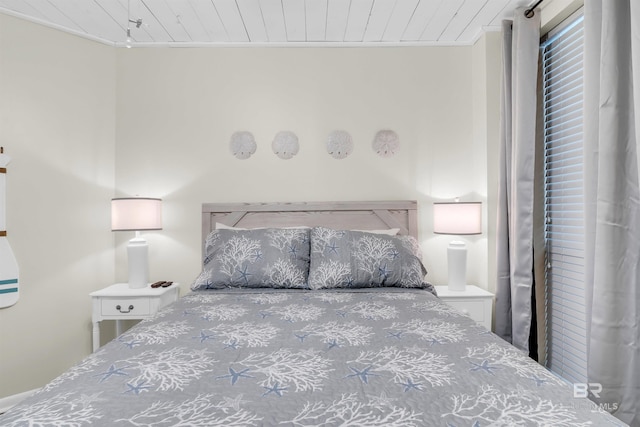 bedroom with ornamental molding and wood ceiling