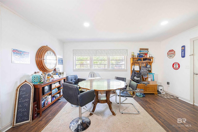 dining area with crown molding and dark hardwood / wood-style floors