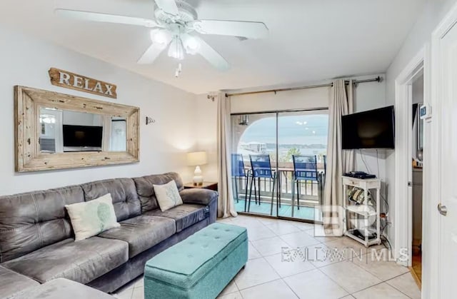 living room featuring ceiling fan and light tile floors