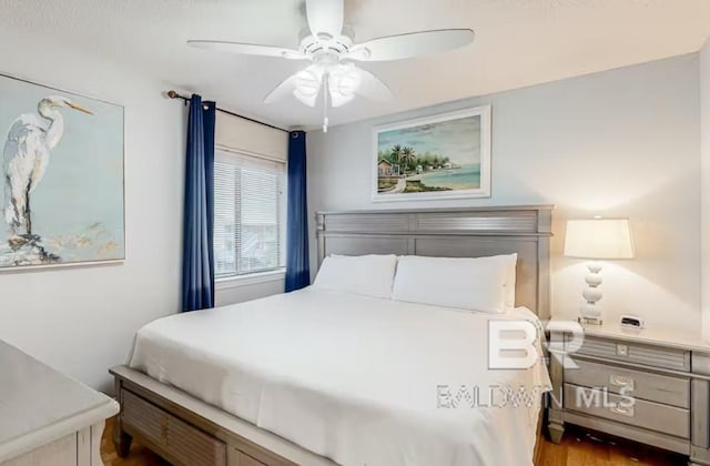 bedroom with wood-type flooring and ceiling fan