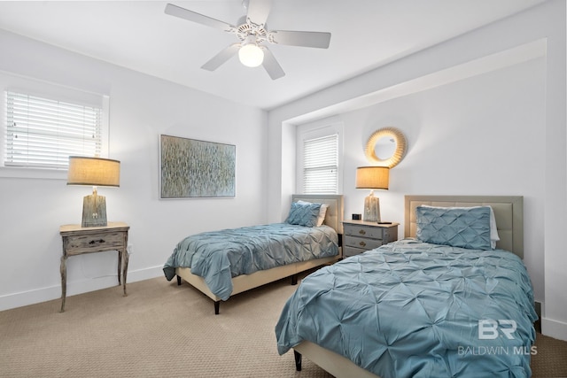 carpeted bedroom with a ceiling fan and baseboards