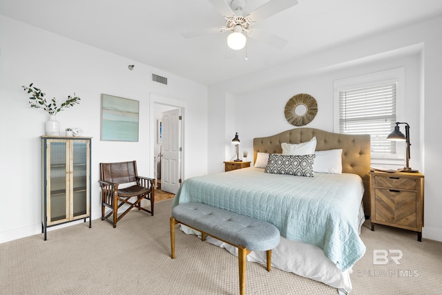 bedroom featuring a ceiling fan, baseboards, light colored carpet, and visible vents