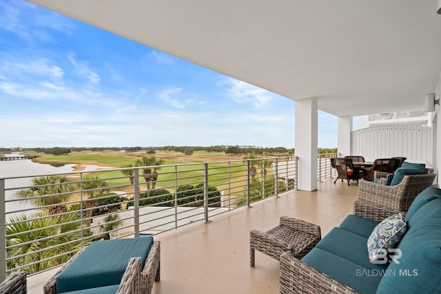 balcony with an outdoor living space and a water view