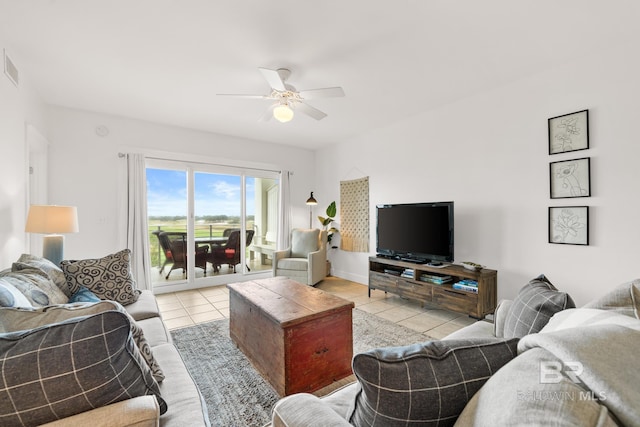 living area featuring a ceiling fan and light tile patterned floors