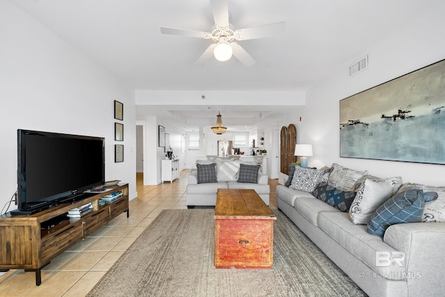 living room featuring light tile patterned flooring, ceiling fan, and visible vents