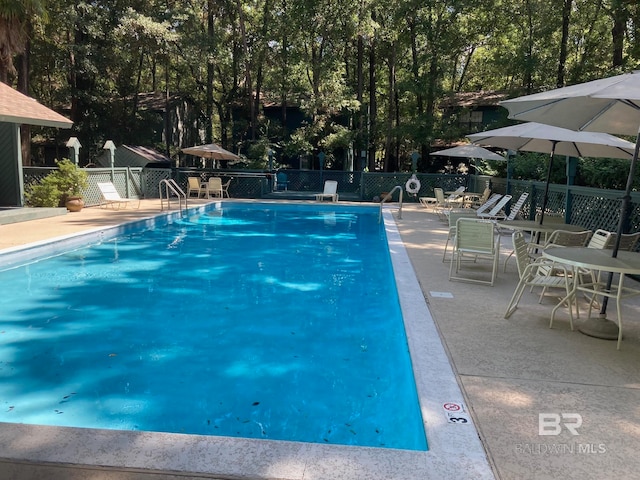 view of swimming pool featuring a patio area