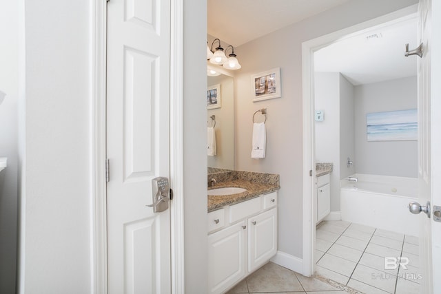 bathroom featuring tile patterned floors, vanity, and a bathing tub