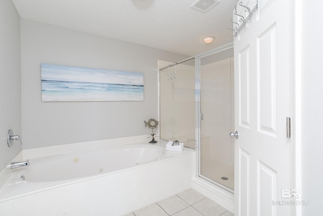 bathroom featuring tile patterned flooring, a textured ceiling, and independent shower and bath