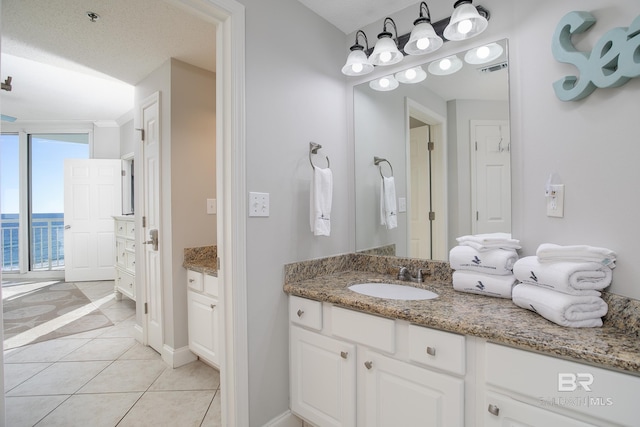 bathroom featuring a textured ceiling, vanity, and tile patterned floors