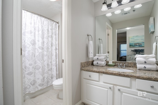 bathroom featuring tile patterned floors, curtained shower, vanity, and toilet