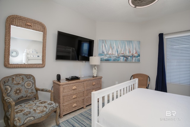 tiled bedroom with a textured ceiling