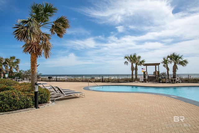 view of swimming pool featuring a water view