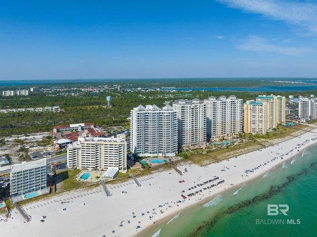 drone / aerial view with a water view and a beach view