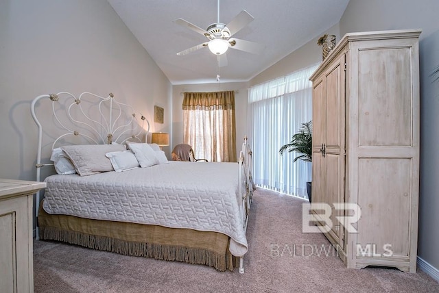 bedroom with a ceiling fan, lofted ceiling, and carpet flooring