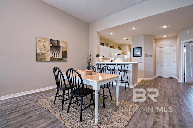 dining area featuring baseboards, dark wood-style flooring, and recessed lighting