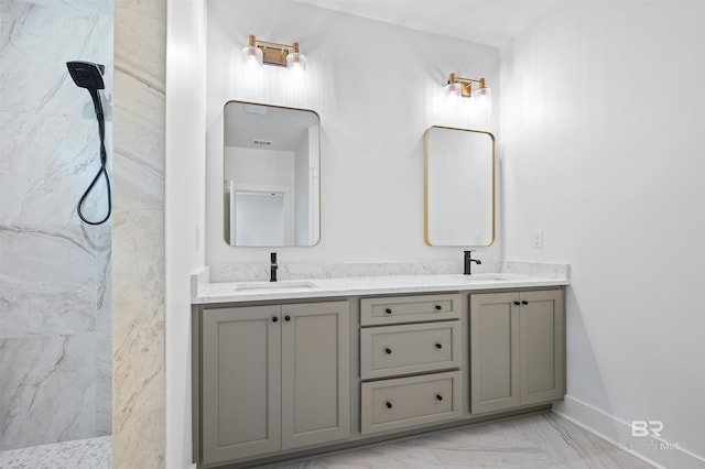659 Island Way, Gulf Shores, AL 36542 - bathroom with marble finish flooring, double vanity, a marble finish shower, and baseboards