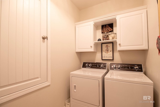 clothes washing area with independent washer and dryer and cabinet space