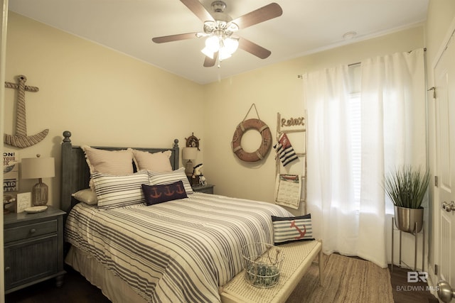 bedroom with ceiling fan and dark wood finished floors