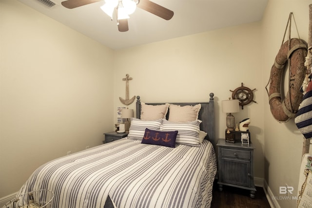 bedroom featuring dark wood-type flooring, visible vents, a ceiling fan, and baseboards