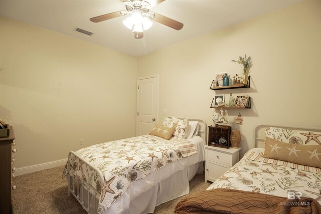 bedroom featuring a ceiling fan, visible vents, light colored carpet, and baseboards