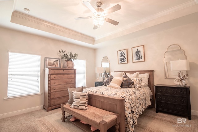 bedroom with baseboards, ornamental molding, carpet, and a tray ceiling