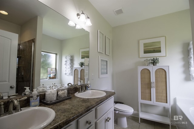bathroom with tile patterned floors, visible vents, a garden tub, and a sink