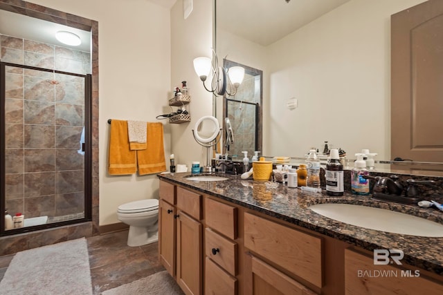 bathroom with toilet, vanity, and an enclosed shower