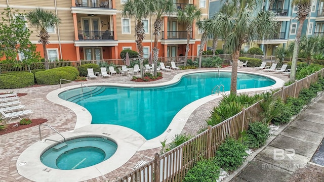 view of pool with a community hot tub and a patio