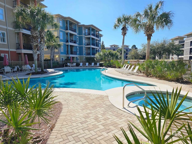 view of pool featuring a patio area and a community hot tub