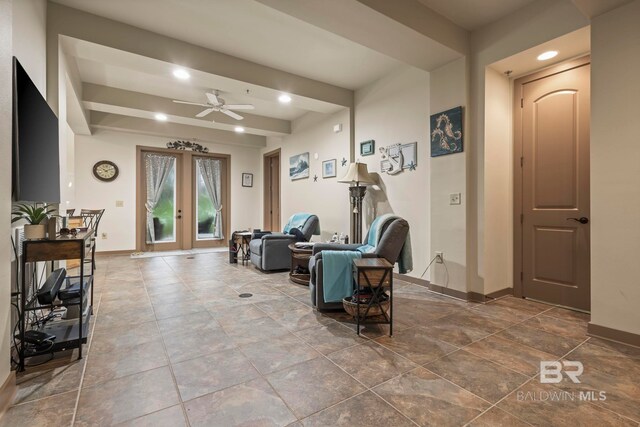 interior space with beamed ceiling, french doors, and ceiling fan