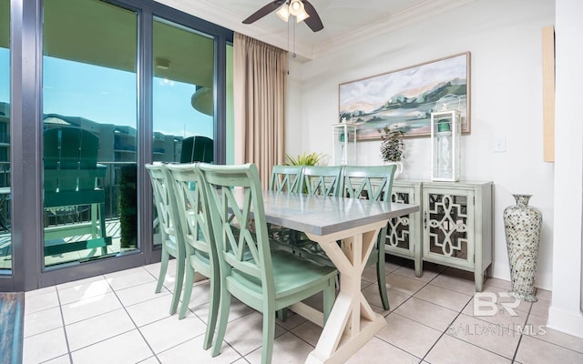 tiled dining area with ceiling fan and ornamental molding