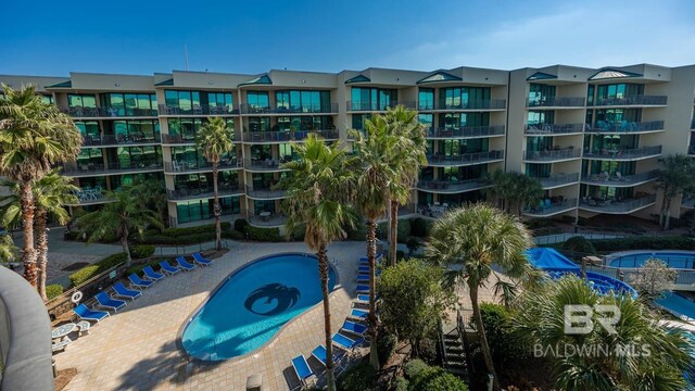 view of pool with a hot tub