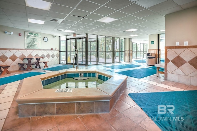 view of swimming pool featuring an indoor hot tub