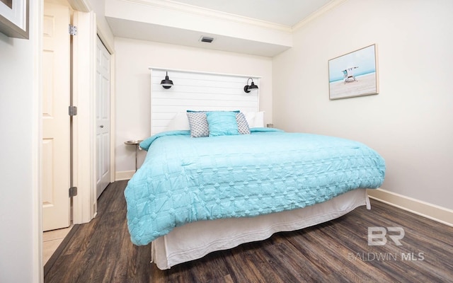 bedroom with hardwood / wood-style flooring and crown molding